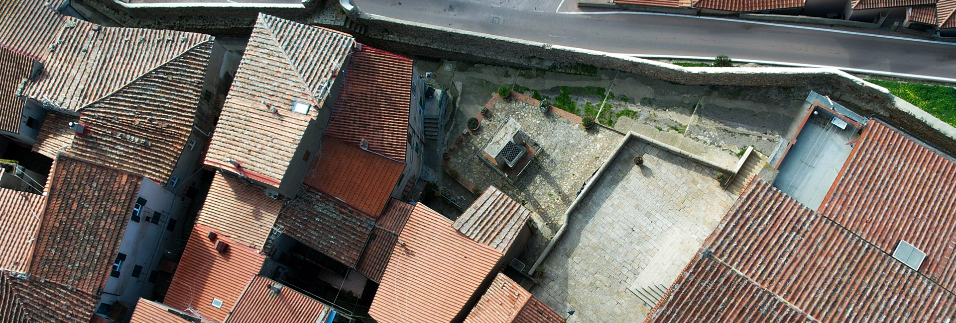 L'immagine mostra una prospettiva aerea di alcuni tetti di Giglio Castello con al centro la Cisterna.