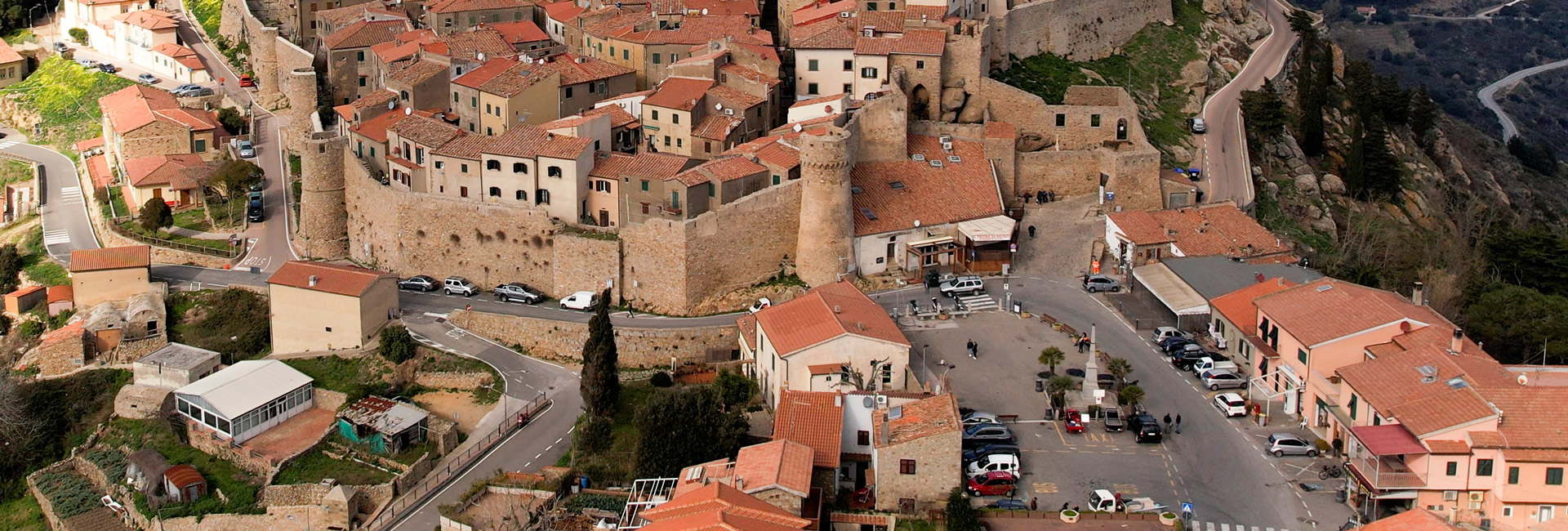 L'immagine mostra una vista aerea ravvicinata di una parte del borgo fortificato, Piazza Gloriosa con altre case adiacenti.